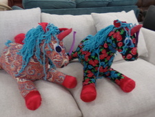 Cloth unicorns.  Appear to be a hand made craft.  Sold separately.  They are hanging out in the couches.  
$15.00