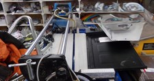 TILE SAW.  Laying flat on top of riser.  In tools department
$93.80