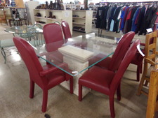 This 6 ft dining table has clear glass top, white stone-look pedestals and is surrounded by 6 red leather chairs.  (not sure of leather authenticity)  2 chairs are armed. others open
$301.80