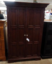 Dark wood armoire -  displayed in our bedroom furniture.
This one has organizing ability inside.
$118.80