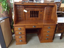 OAK ROLL TOP DESK.  This desk top has more little drawers and file options than most.  Base has computer tower and other organizing drawers.  
Enter the store, walk straight then go to the right 
$419.90