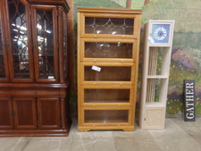 OAK BOOK CASE.  EACH SHELF HAS GLASS PROTECTION.  
$521.30