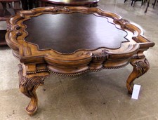 Ornate wood and leather coffee table 
$550.00